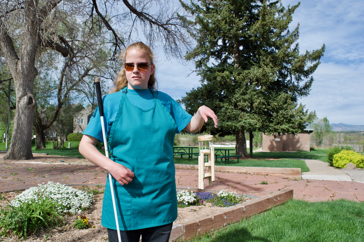 C.G. out front holding up her wooden wind chimes