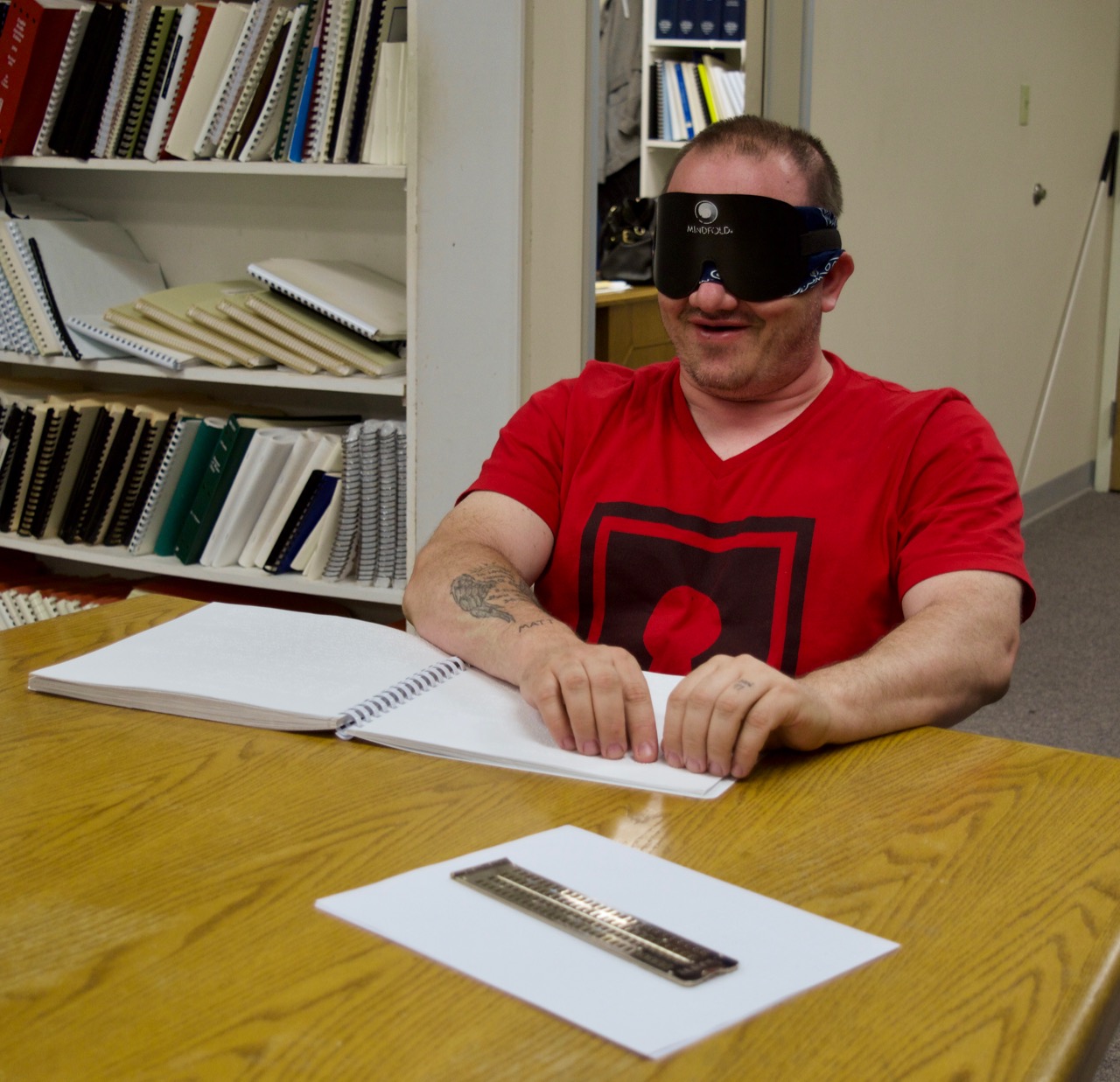 Charles S. reading from his Braille instruction book