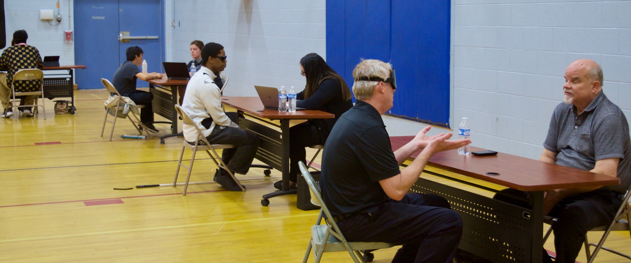 Tables in the exhibit area are thronged with job seekers and students