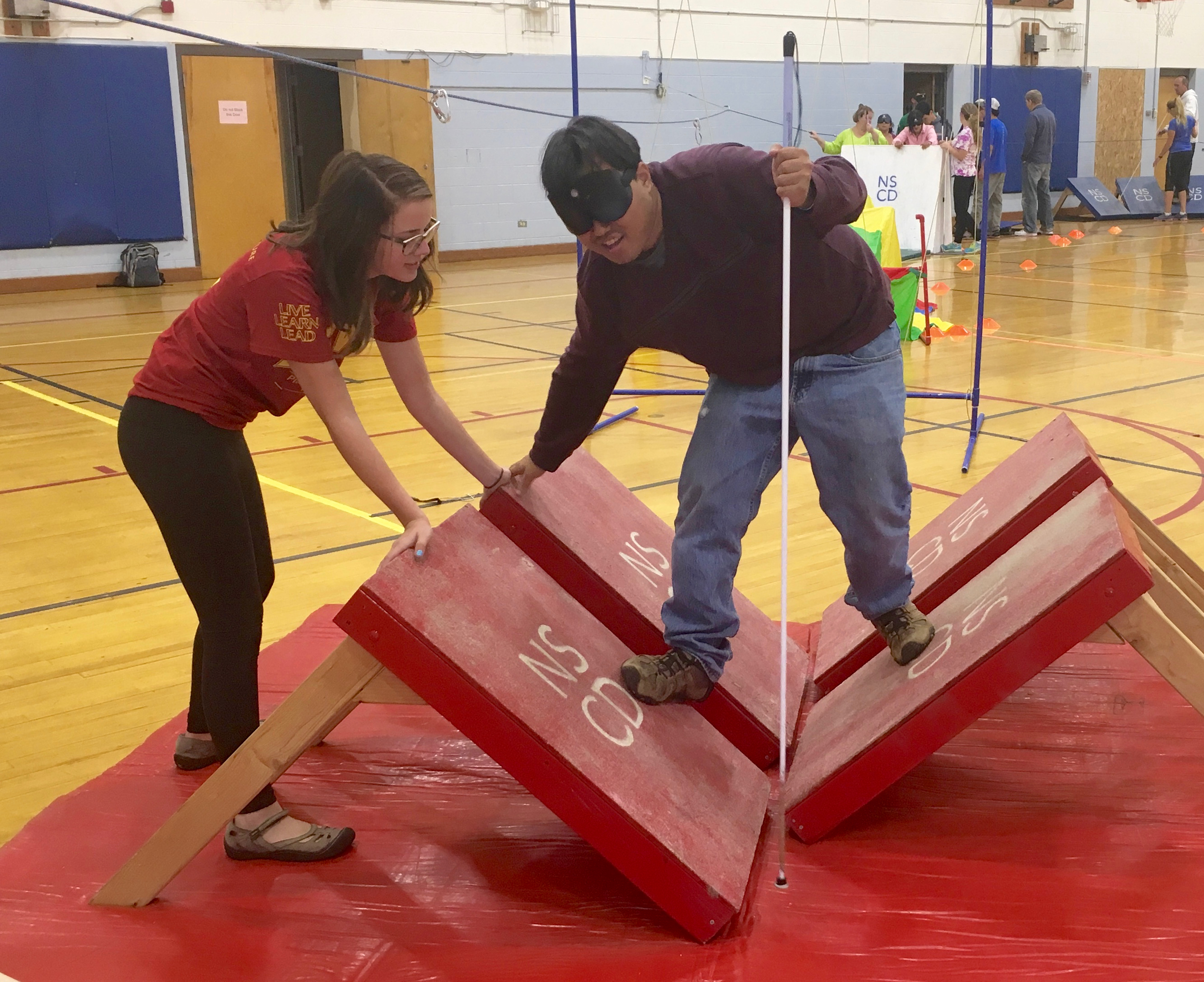 Joey bounces over quadangle steps on NSCD's obstacle course