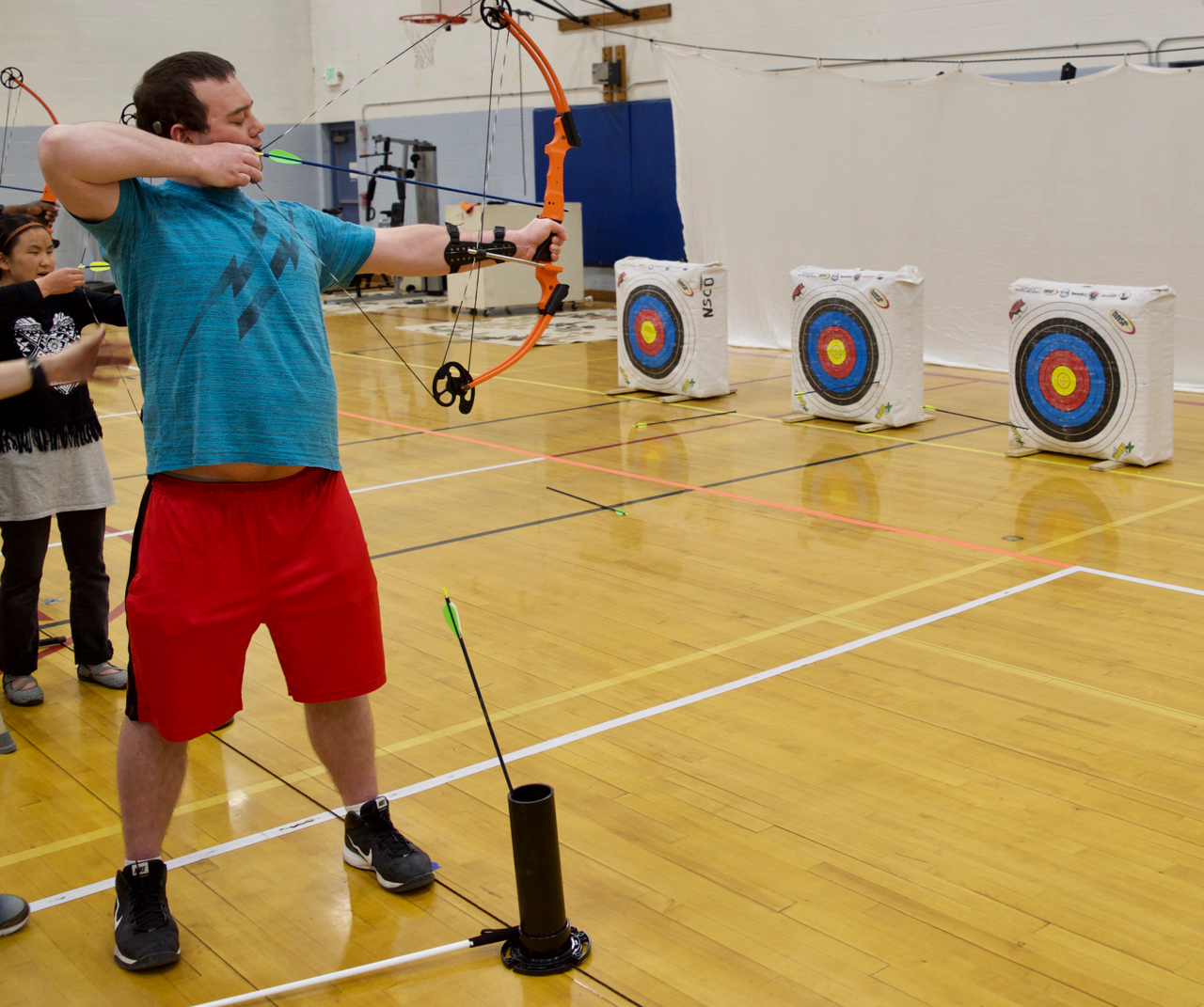 Zach H. takes aim with his Bow in Archery Class